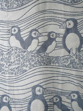 Pattern of puffins on a textured fabric background
