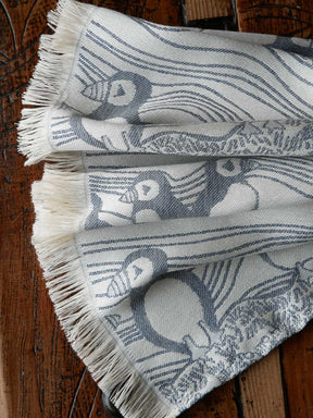 Textile with bird pattern on a wooden surface