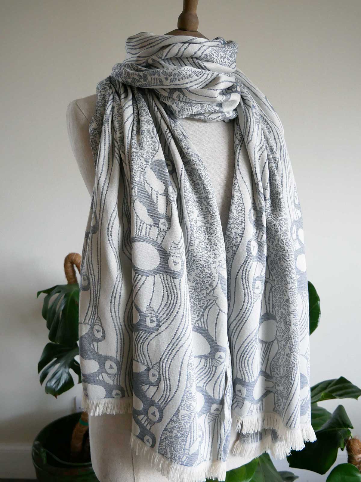Mannequin wearing a patterned scarf with a white background