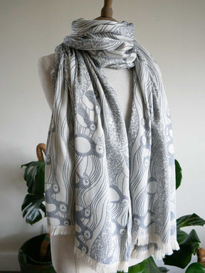 Mannequin wearing a patterned scarf with a white background