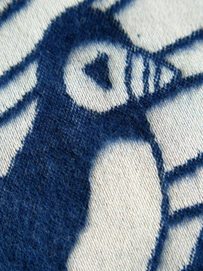 Close up of a white and blue fabric with a puffin