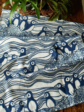 White and blue blanket with puffin pattern