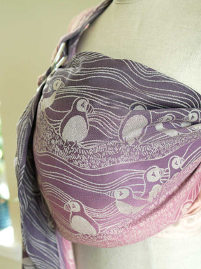Close up of a pink and purple ring sling with puffin pattern on a mannequin