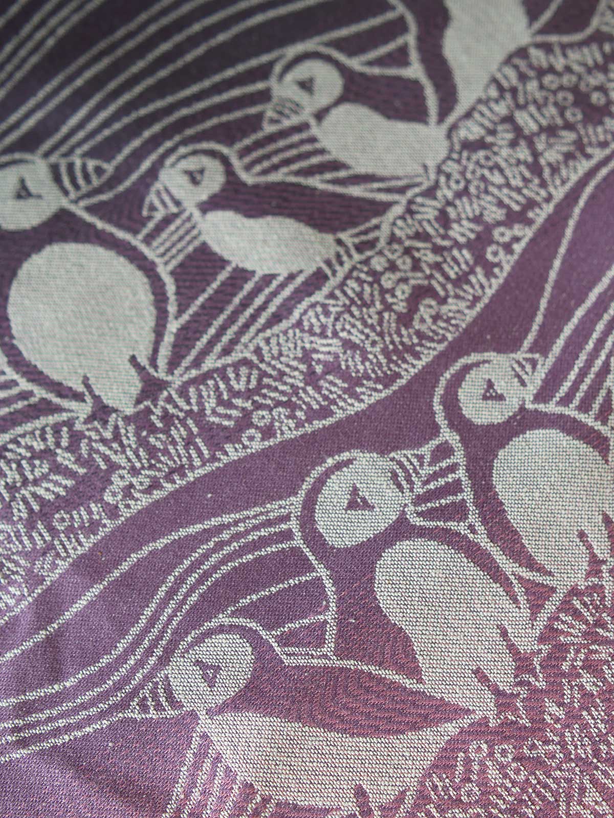 Close up of pink and purple fabric with puffin pattern