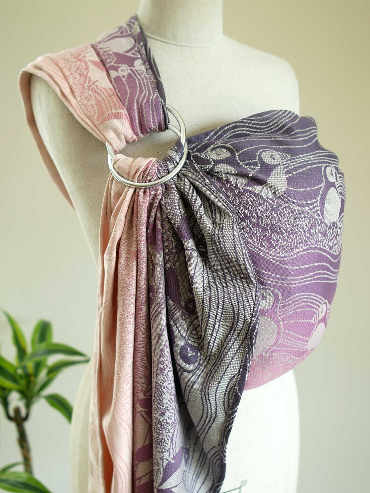 Side view of a pink and purple ring sling with puffin pattern on a mannequin