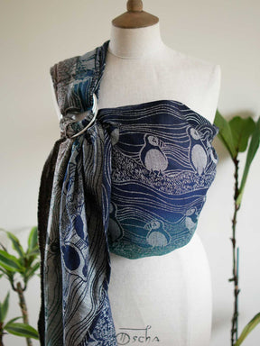 Blue and green ring sling with puffin design on a mannequin.