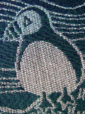 Close up of a puffin on a blue fabric
