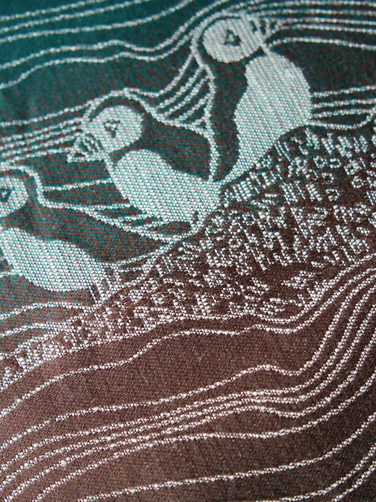 Close up of puffins on a green and brown fabric