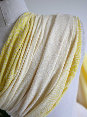 Yellow fabric on a mannequin.