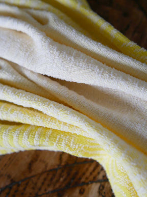 Close up of yellow and white woven fabric 
