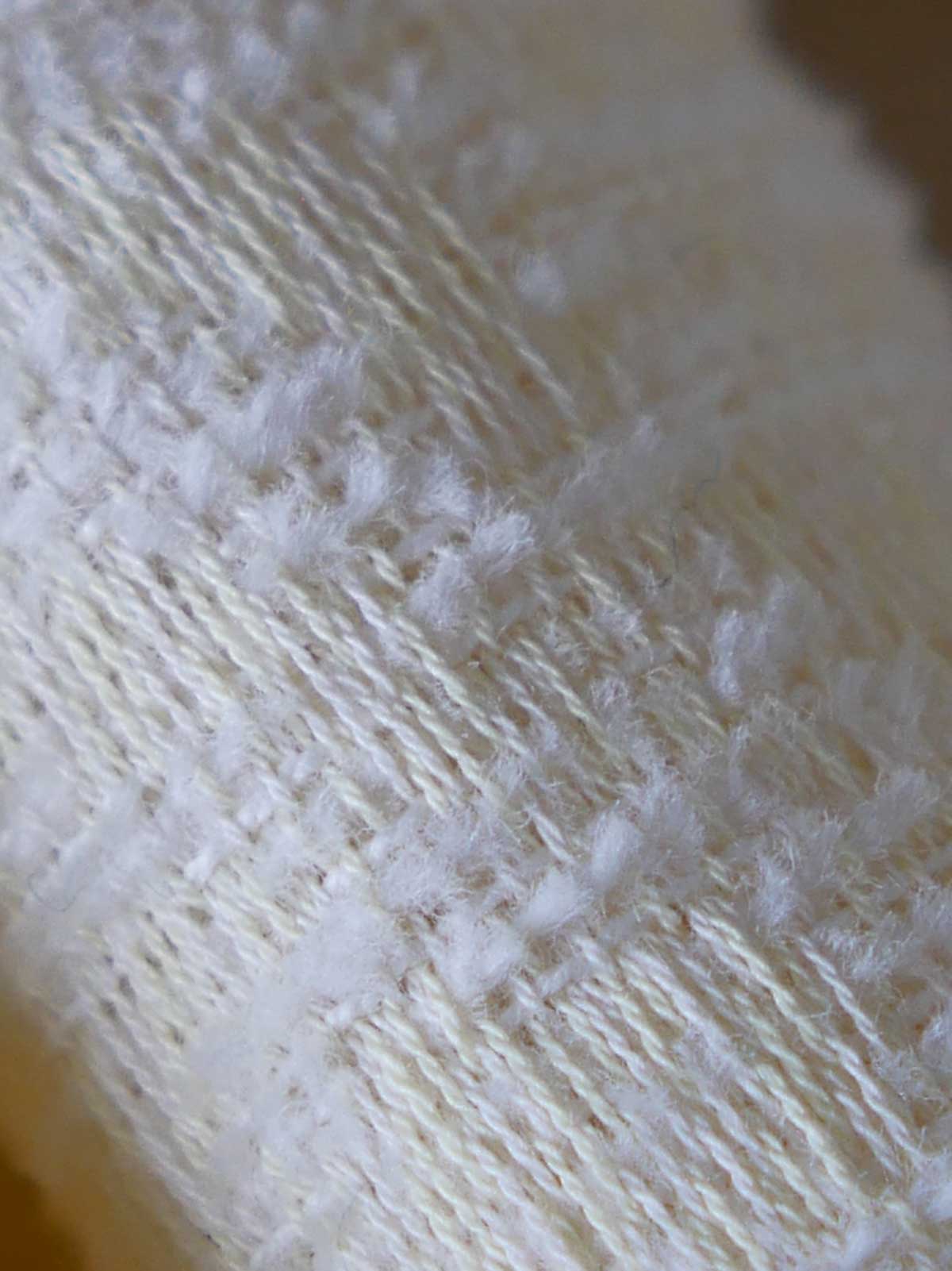 Close up of yellow and white woven fabric 