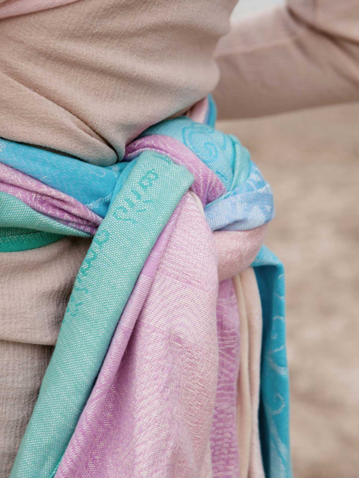 Close-up of a woven wrap knotted with a blurred background