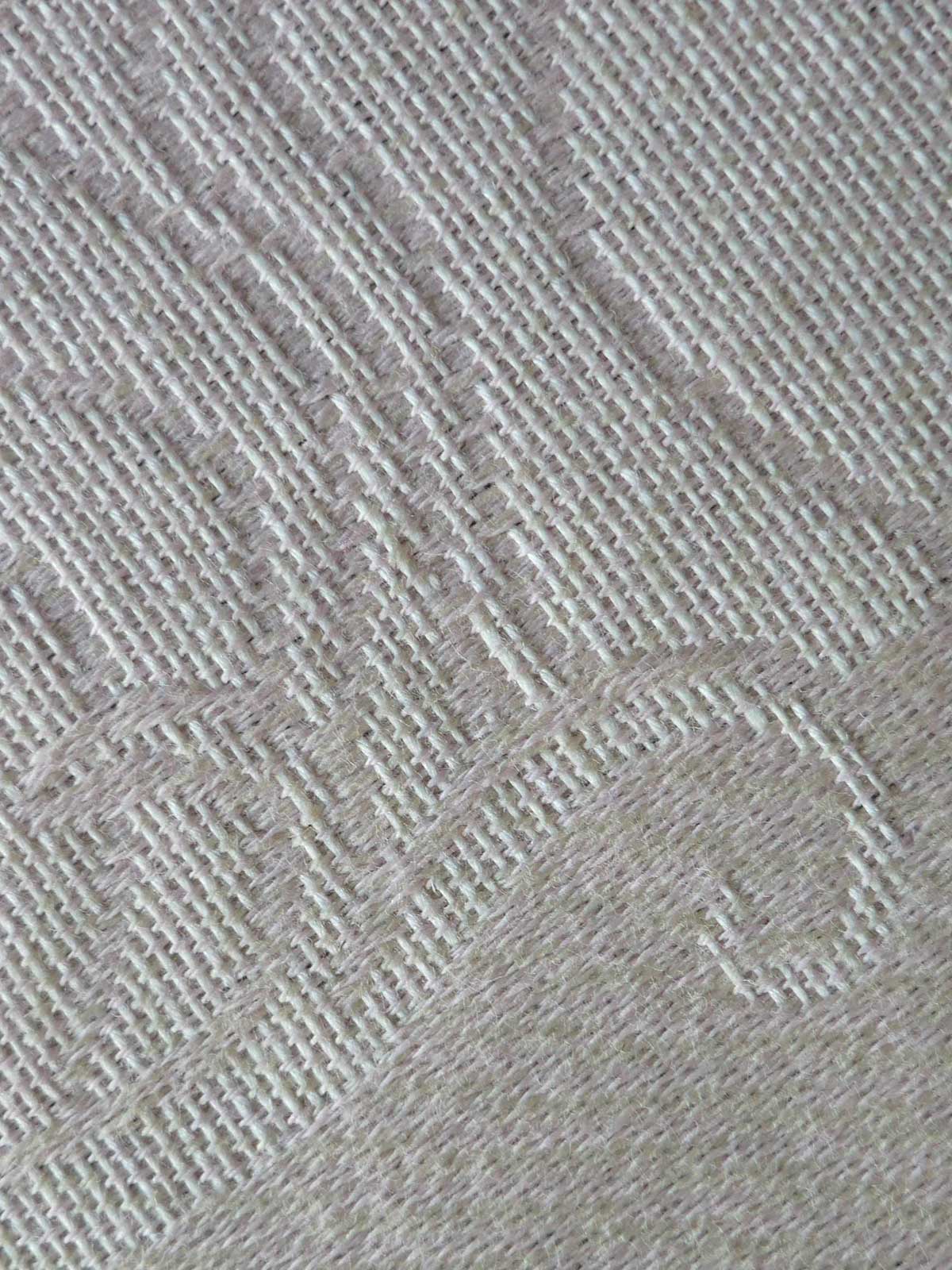 Close-up of a textured gray fabric with a subtle pattern