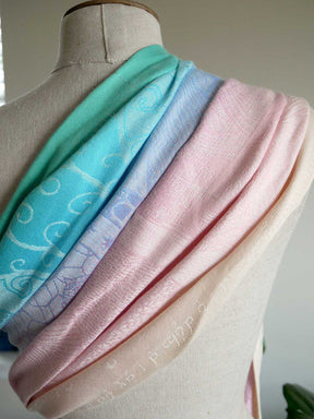 Pastel-colored ring sling on a mannequin with a neutral background