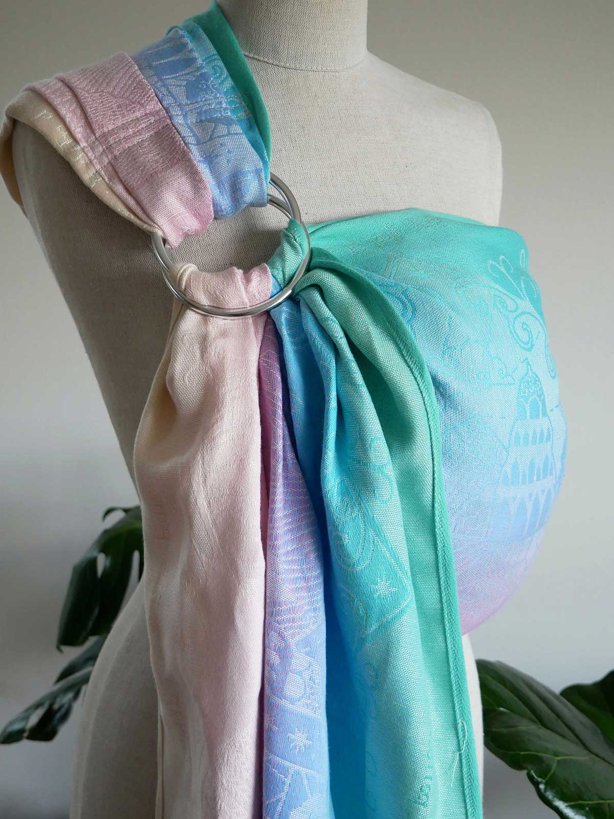 Pastel-colored baby wrap on a mannequin with a neutral background