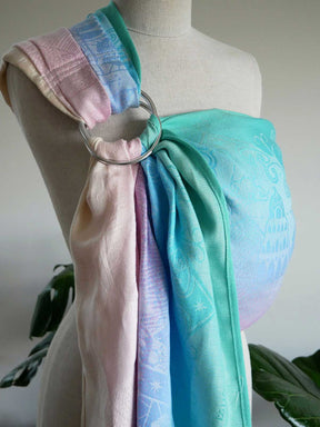 Pastel-colored baby wrap on a mannequin with a neutral background