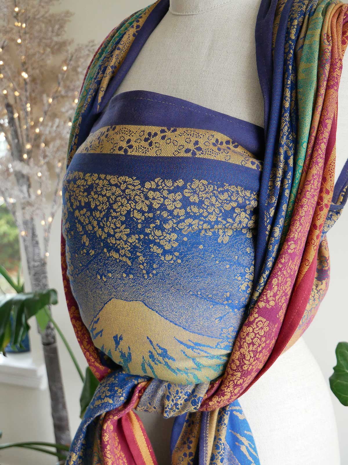 Colorful fabric draped over a mannequin with a scenic design.