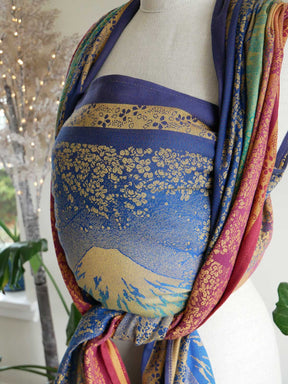 Colorful fabric draped over a mannequin with a scenic design.