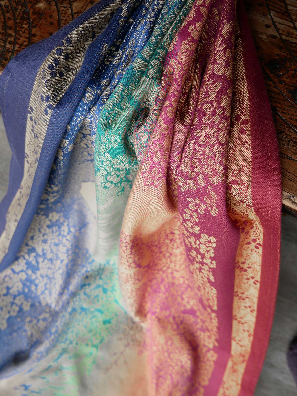Close-up of colourful fabric with floral patterns on a wooden surface