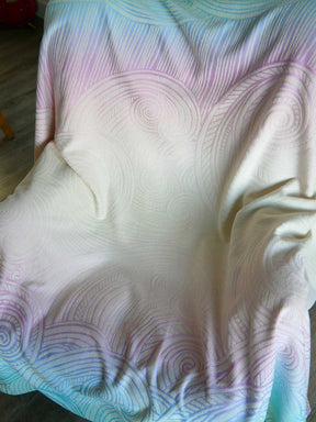 Colorful blanket with wave pattern on a wooden floor