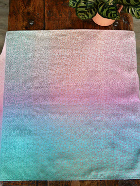 Gradient fabric with lace pattern on a wooden surface