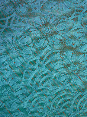 Close-up of a textured teal fabric with a subtle pattern