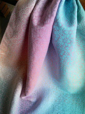 Patterned fabric in pink and blue with a visible texture.