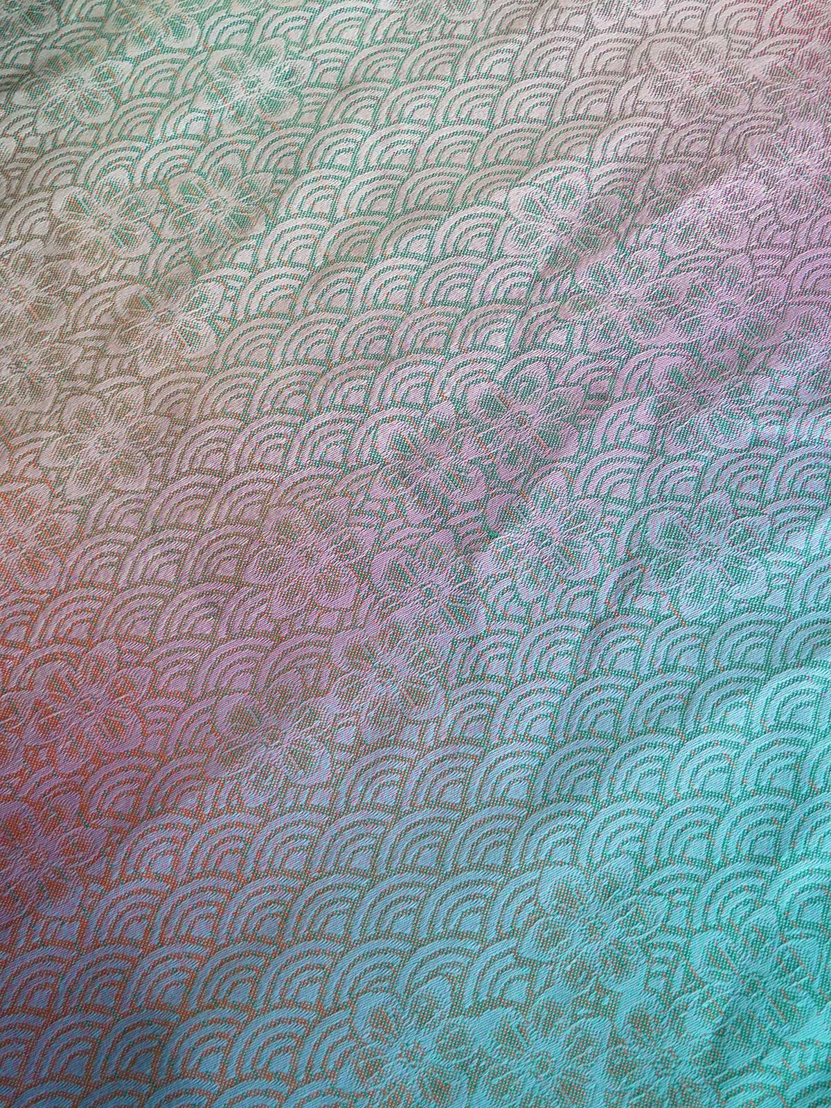 Multicolored fabric with a pattern of curved lines and floral elements