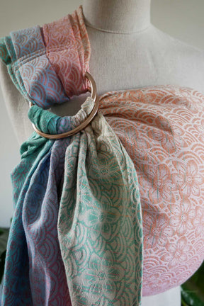 Ring sling in pastel colors on a mannequin with a gold ring.