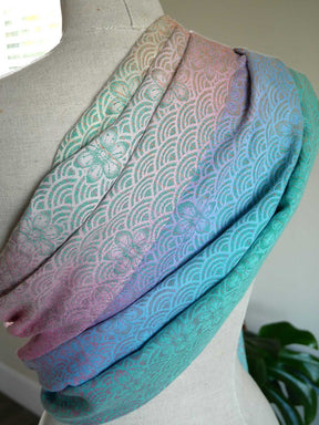 Multicolored patterned fabric draped over a mannequin with a blurred background
