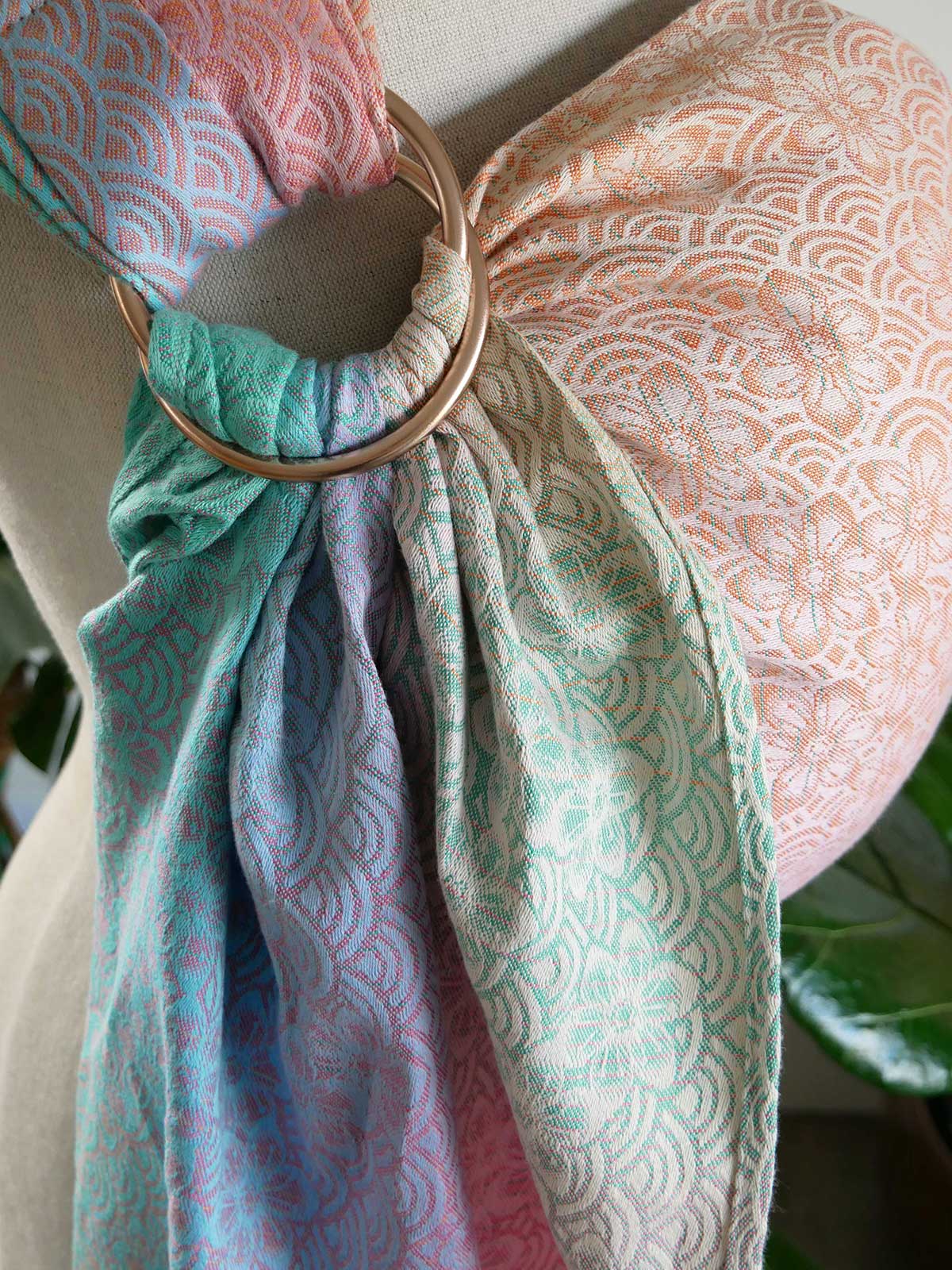 Sling with a gold ring draped over a mannequin