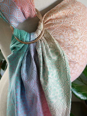 Sling with a gold ring draped over a mannequin