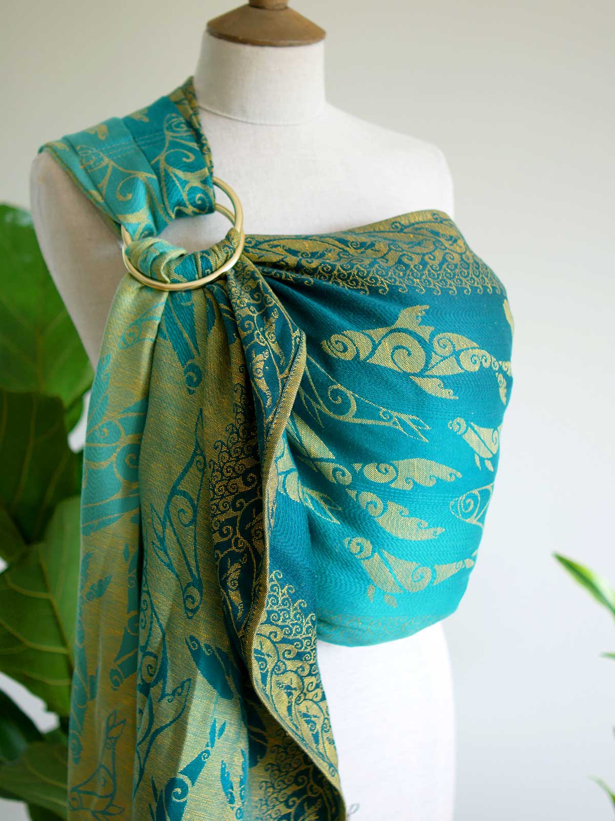 Teal ring sling with gold selkies on a mannequin