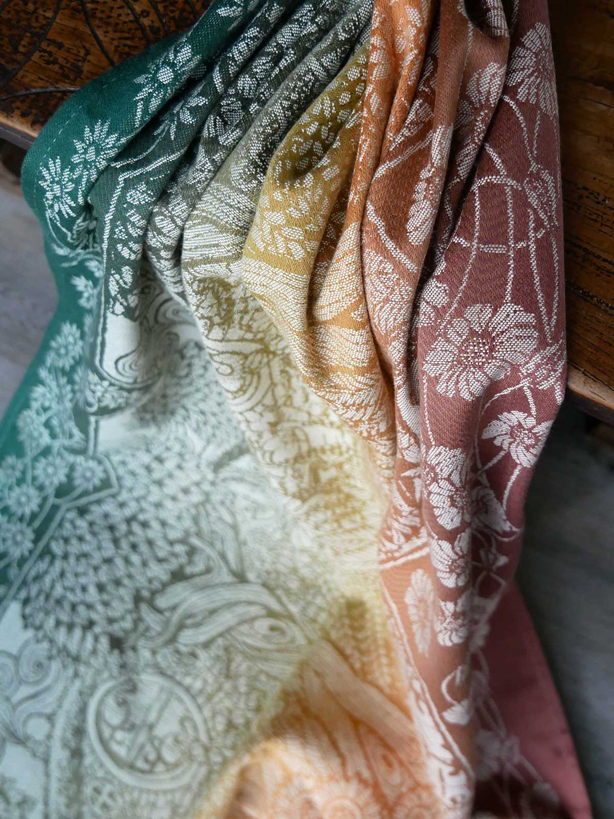 Set of folded fabric swatches in various colors with patterns.