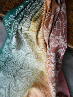 Set of folded fabric swatches in various colors with patterns.