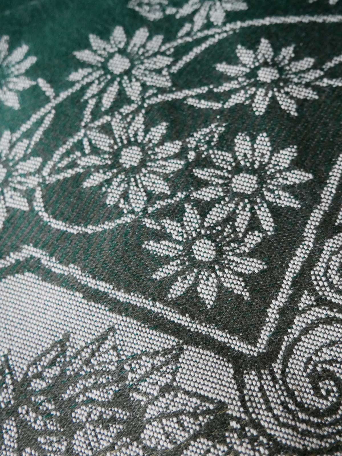 Close-up of floral patterned fabric with green background
