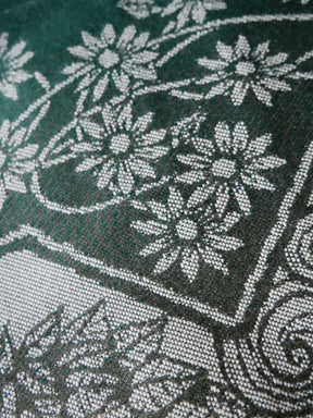 Close-up of floral patterned fabric with green background