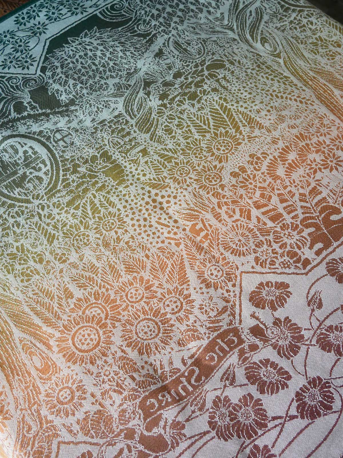 Close-up of a fabric with intricate floral and geometric patterns.