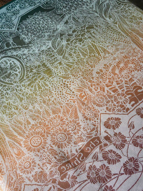 Close-up of a fabric with intricate floral and geometric patterns.