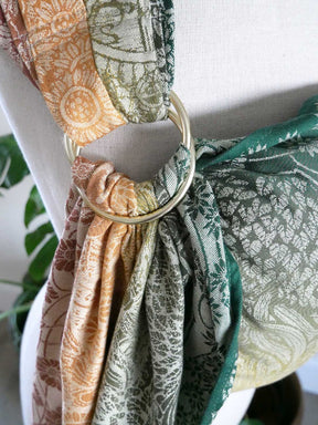 Close-up of Shire Harvest Light Ring Sling, featuring green, brown, and beige patterns.