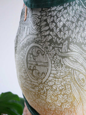 Close-up of a patterned fabric with intricate designs on a plain background