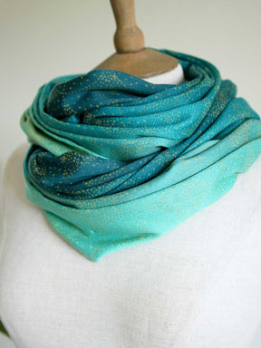 Infinity loop with teal fade and gold details double looped on mannequin