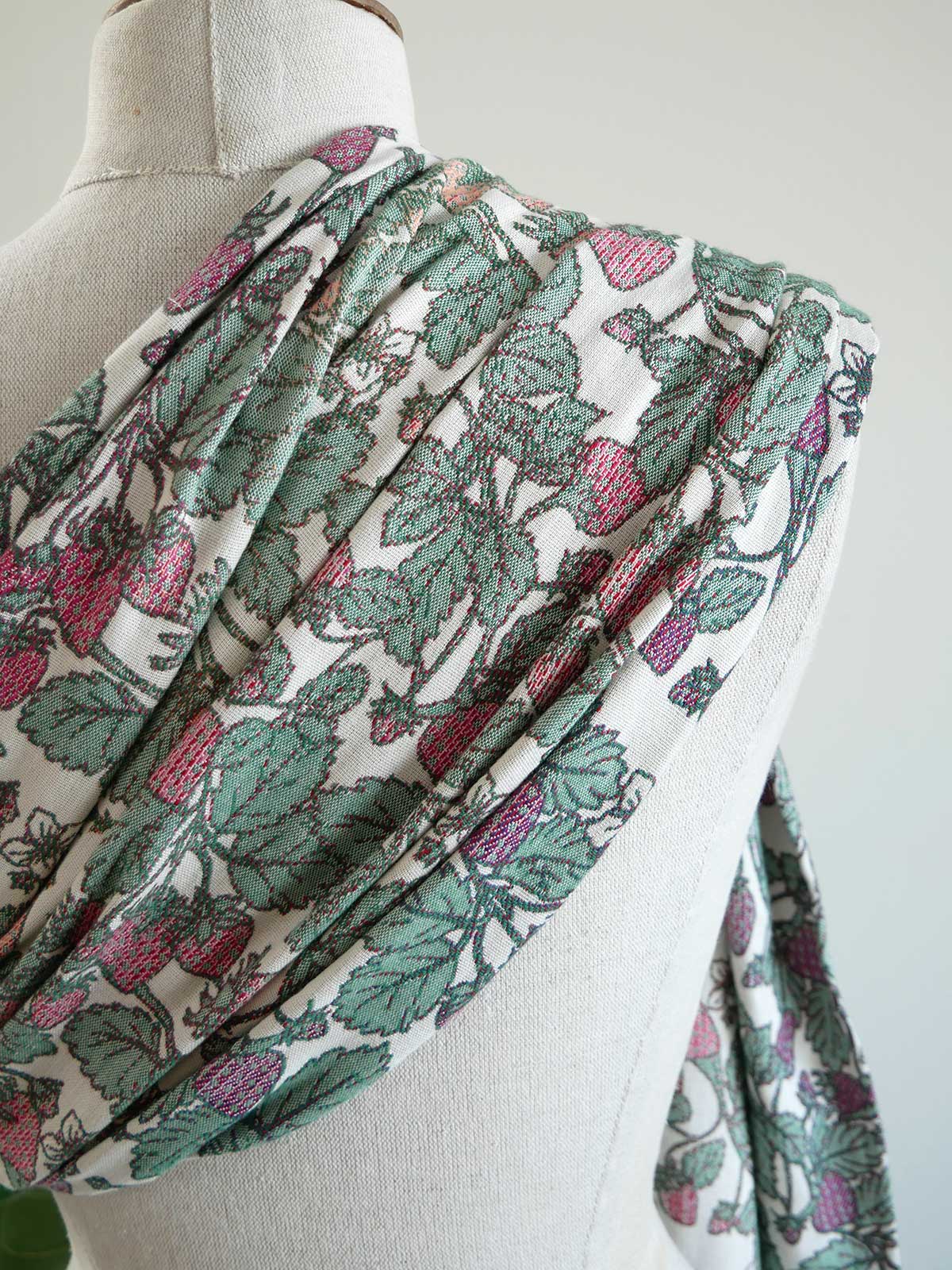 Floral patterned fabric draped over a mannequin on a light background