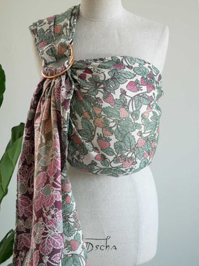 Strawberry patterned baby carrier on a mannequin.