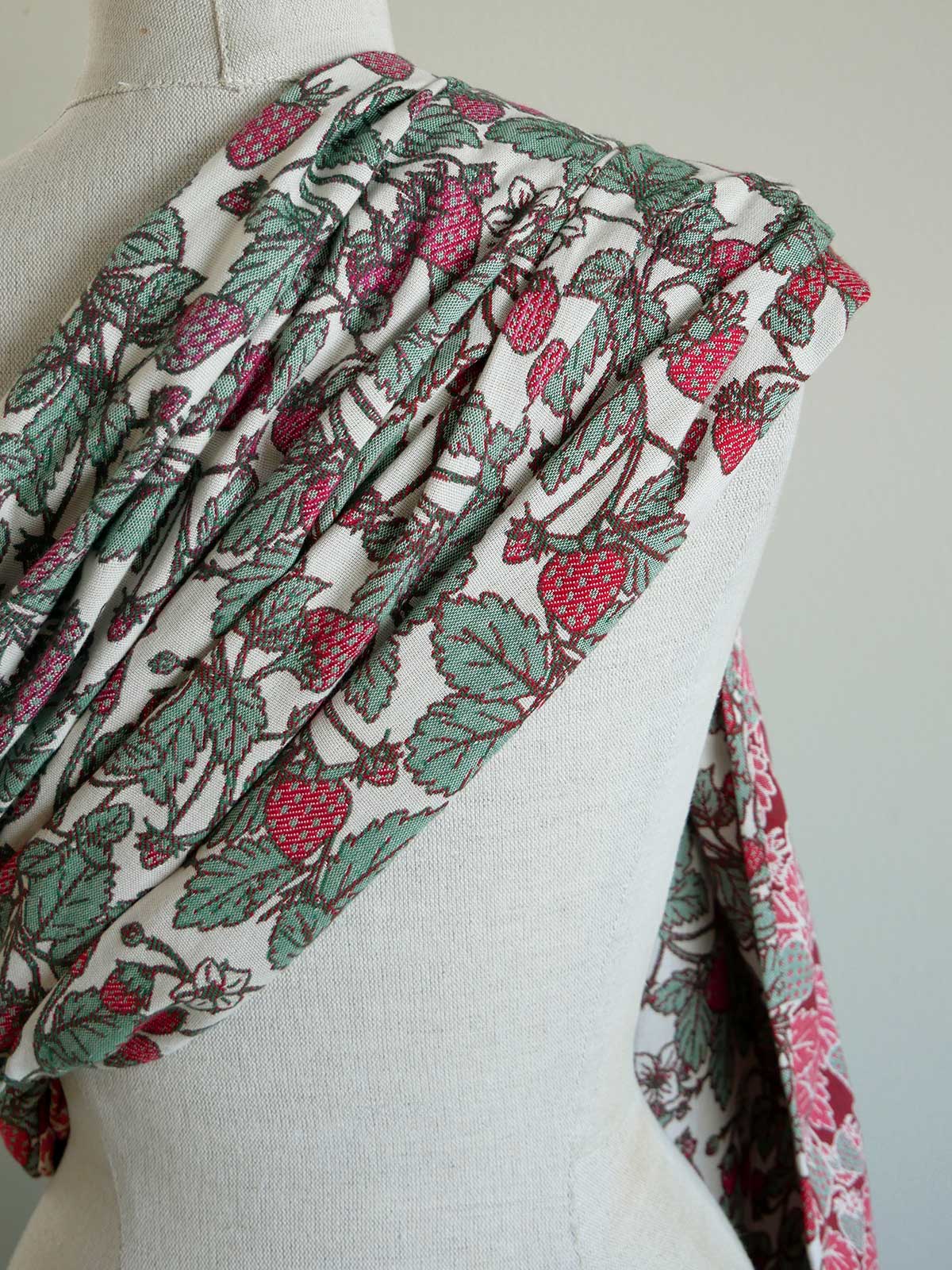 Fabric with strawberry pattern draped over a mannequin