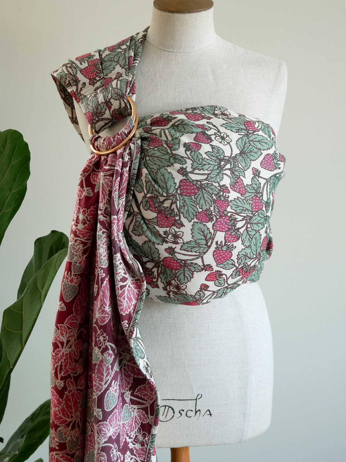 Rng sling on a mannequin with a strawberry pattern.