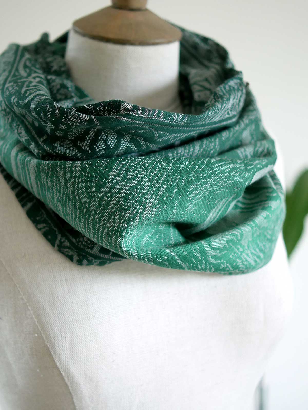 Side view of cowl in the green soft fabric. 
