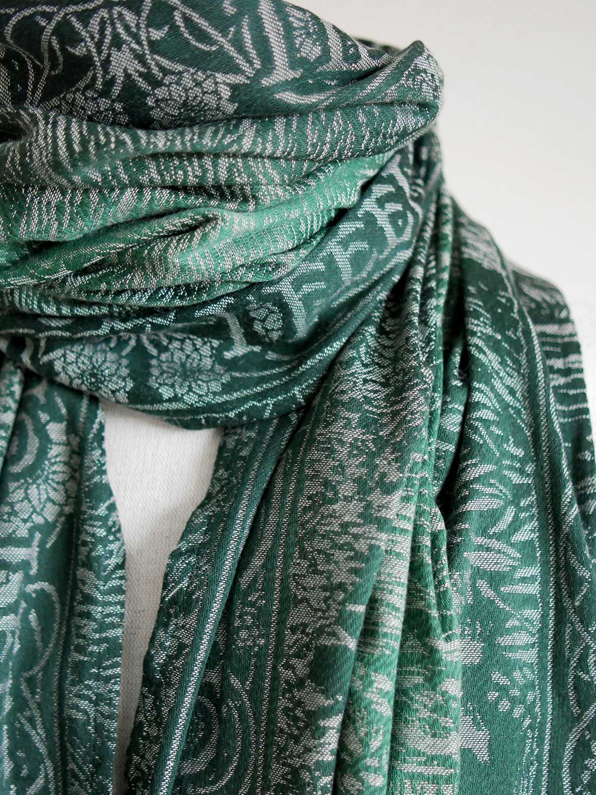 Close up view of the green scarf on mannequin. 