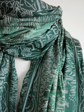 Close up view of the green scarf on mannequin. 