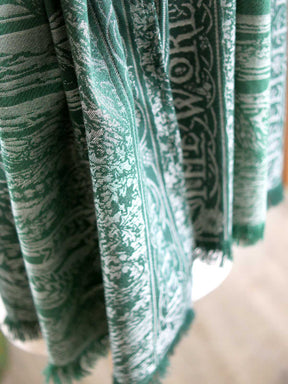 Draped green scarf highlighting fringed edge. 